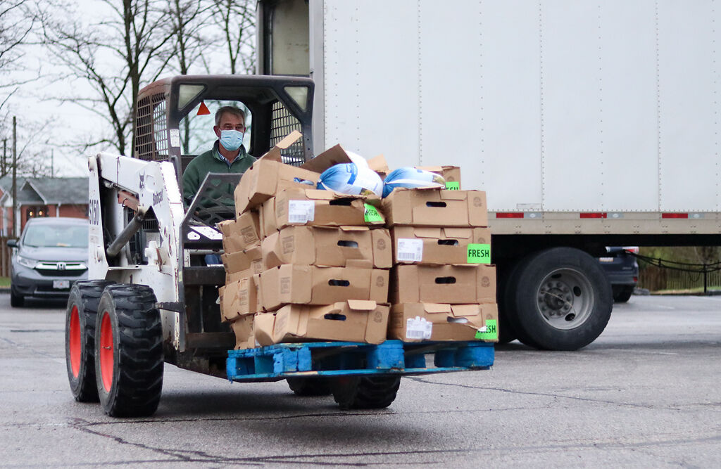 Fresh, whole turkeys are brought from a truck